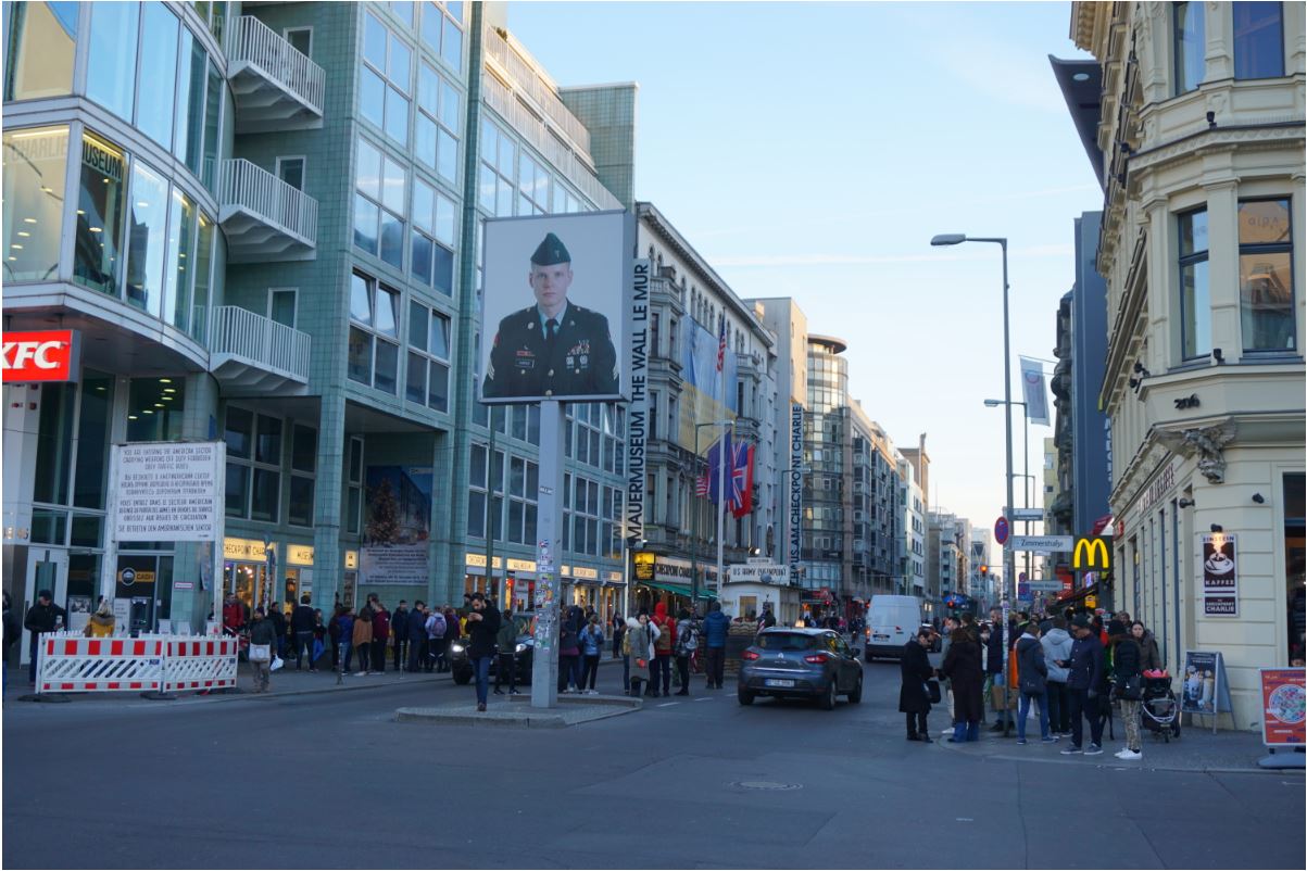 Replica of Checkpoint Charlie with guard booth and actors portraying soldiers
